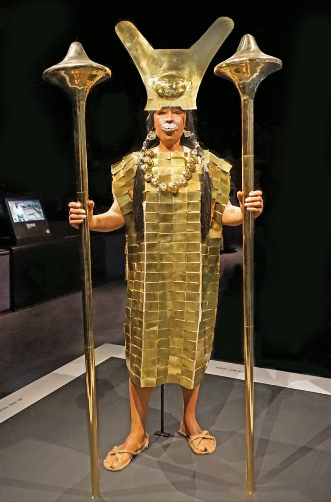 mujer sujetando dos varas doradas