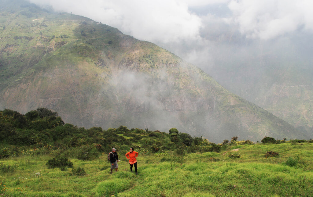 Vista del Bosque de Zárate con caminantes en primer plano y cerros cubiertos de niebla al fondo, en la provincia de Huarochirí