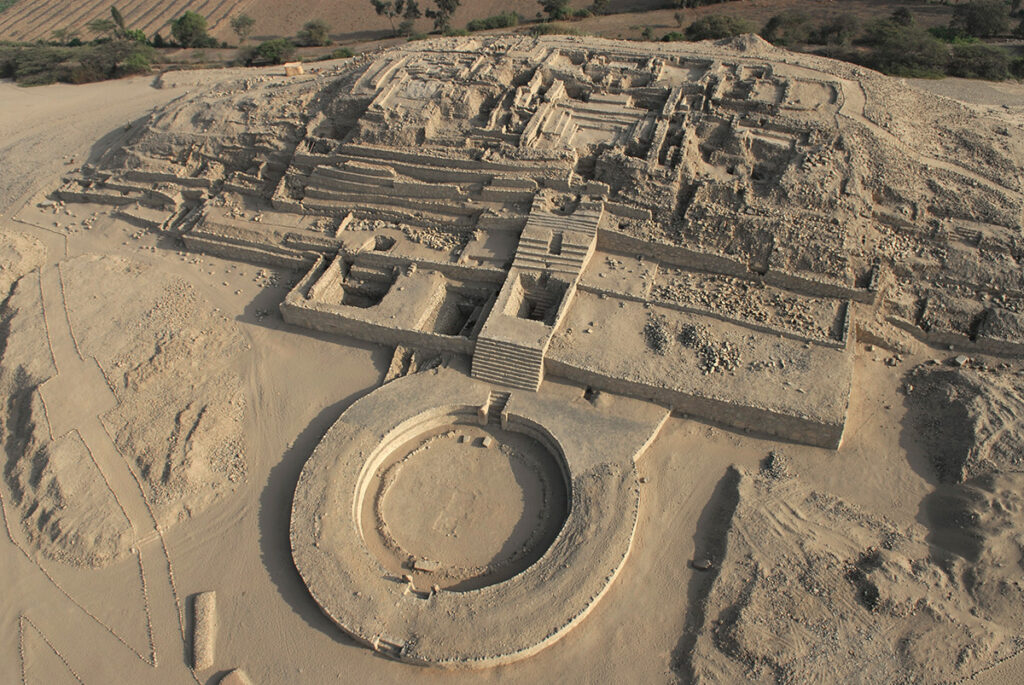 Vista aérea del complejo arqueológico de Caral, con sus plazas circulares y pirámides escalonadas que evidencian una planificación urbana avanzada