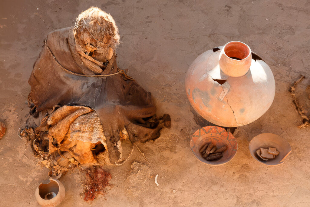 Fardo funerario nazca junto a vasijas de cerámica sin torno y ofrendas halladas en el cementerio de Chauchilla