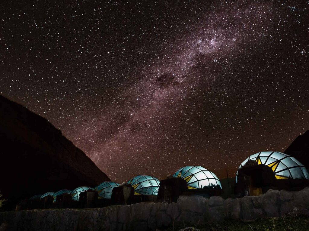 Domos de Sky Camp iluminados bajo la Vía Láctea en Soraypampa, Cusco, uno de los glampings andinos ideales para observar el cielo nocturno en los Andes peruanos