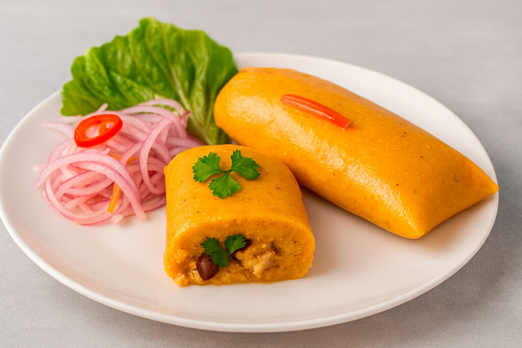 Tamal ayacuchano servido en plato blanco con cebolla y ají, elaborado con maíz blanco, manteca y anís, un clásico de la cocina tradicional de Ayacucho